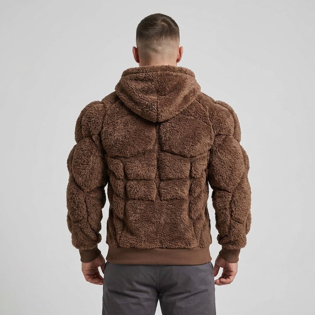 Back view of a model wearing the Kouvr Titan Sherpa Muscle Hoodie, a padded fleece pullover.