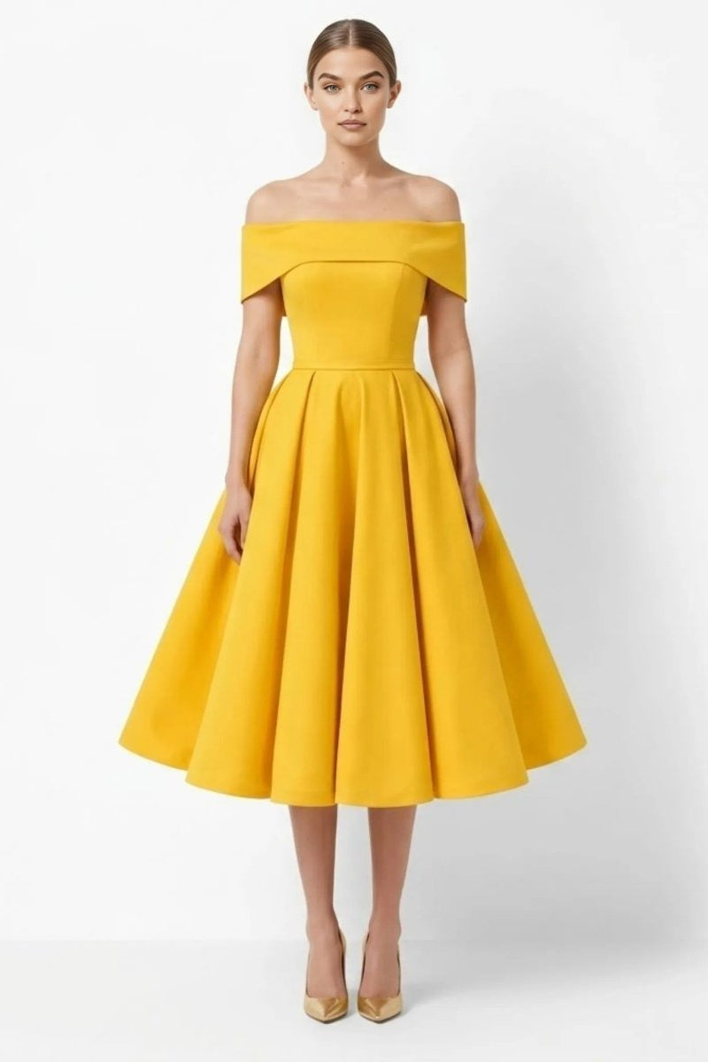 Front view of woman wearing elegant gold off the shoulder midi dress with pleated skirt by Fenlo Form