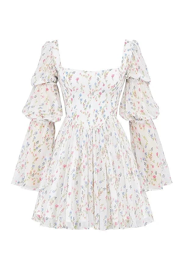 Model wearing the Kouvr Fashion white floral puff sleeve mini dress