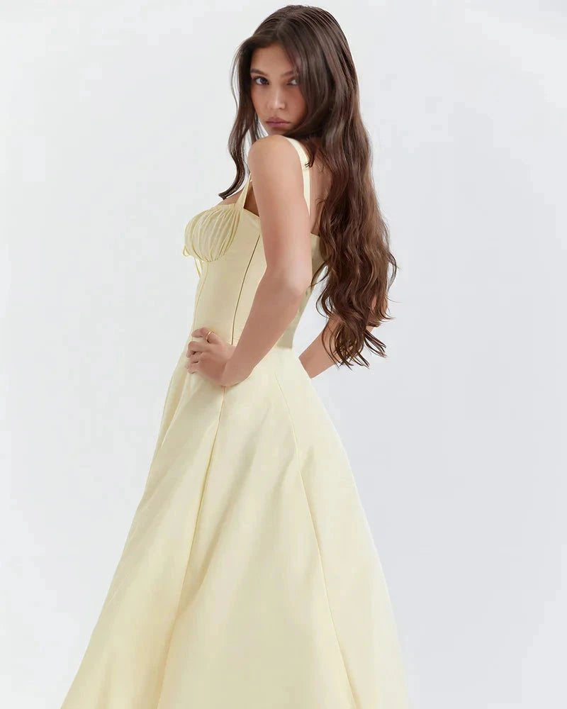 Woman wearing a light yellow dress against a white background