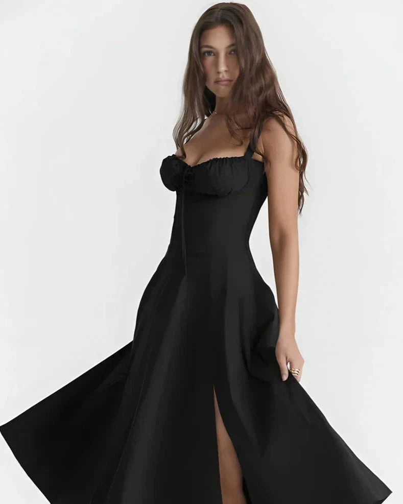 Black dress with a sheer top and high slit on a white background