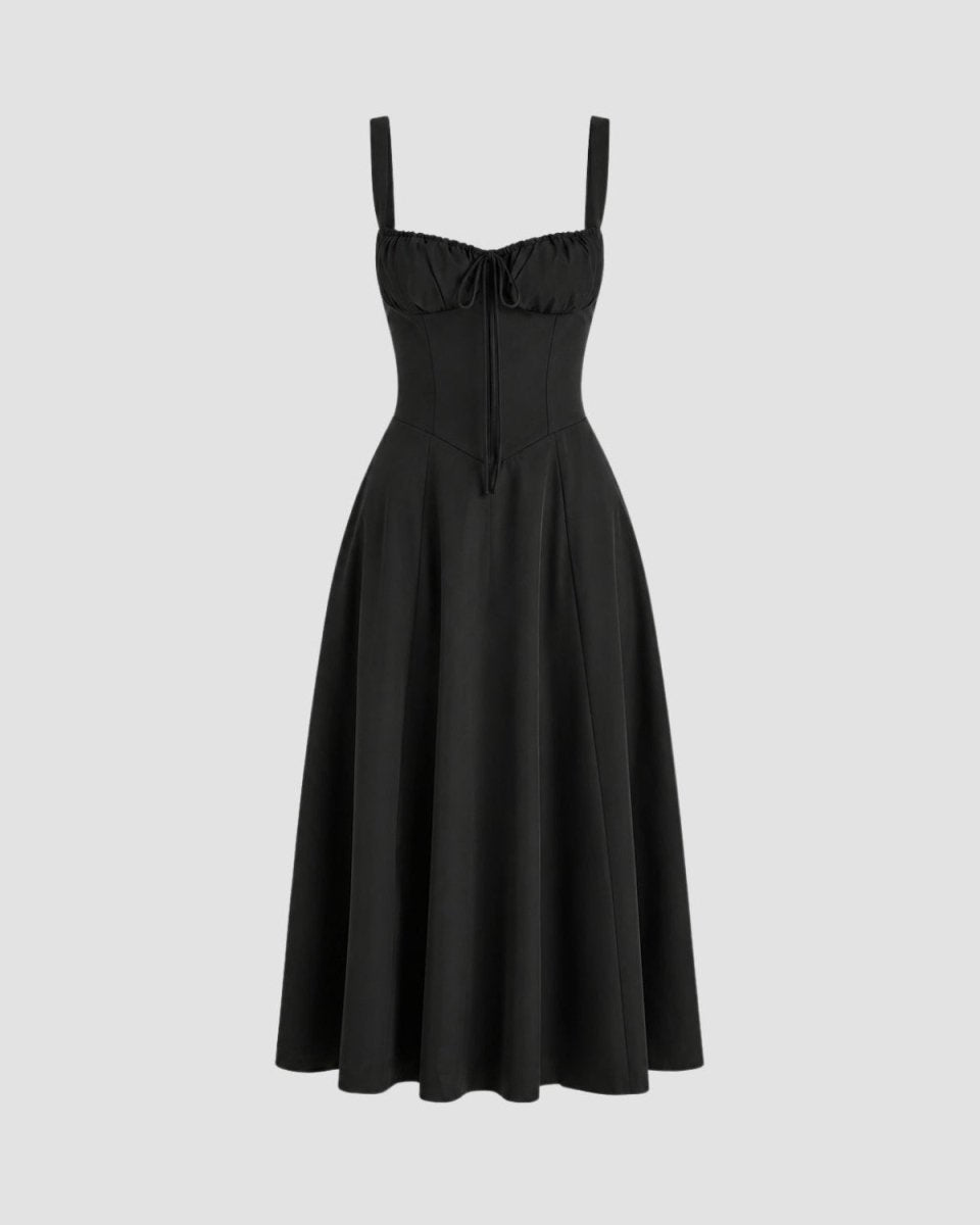 A black sleeveless midi dress with a sweetheart neckline, gathered corset-style bodice, thin shoulder straps, and a flared skirt, shown on a light gray background.