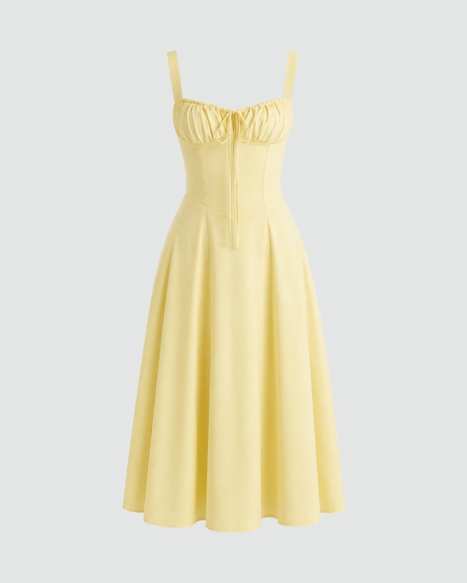A pale yellow sleeveless midi dress with thin shoulder straps, a gathered sweetheart neckline, and a flared skirt, shown on a light gray background.