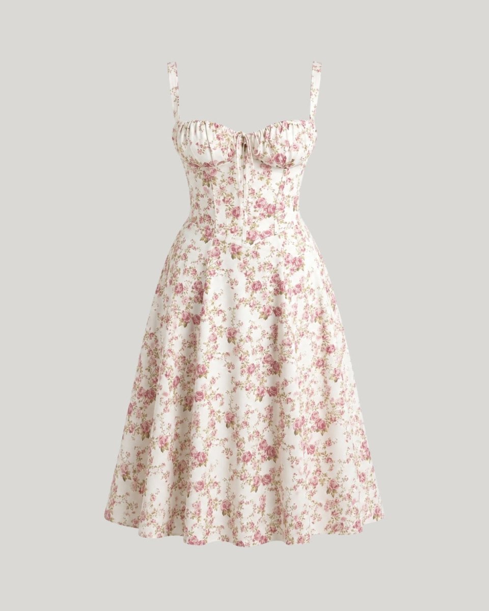 A sleeveless A-line midi dress with a sweetheart neckline, gathered bust, and thin shoulder straps, featuring a pink and red floral print on a cream background. The dress is shown against a solid light gray background.