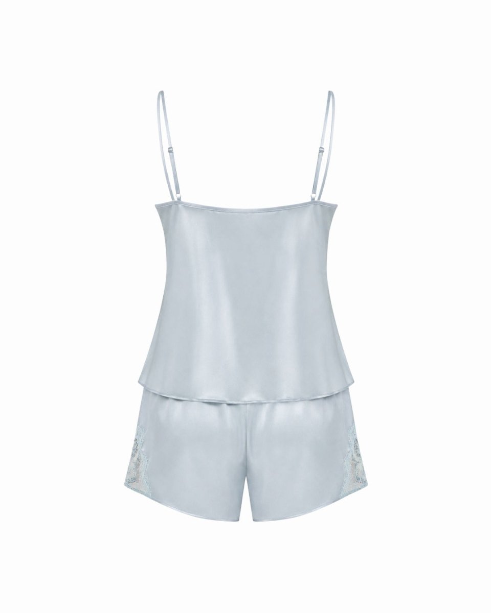 A light blue satin camisole top with thin shoulder straps and matching shorts featuring subtle embroidered details on the lower left leg, displayed against a solid white background.