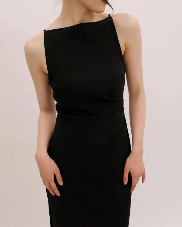 Black one-shoulder dress worn by a model on a plain background
