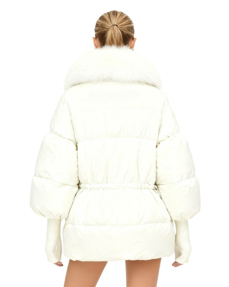 Person wearing a white kouvr puffer coat on a white background