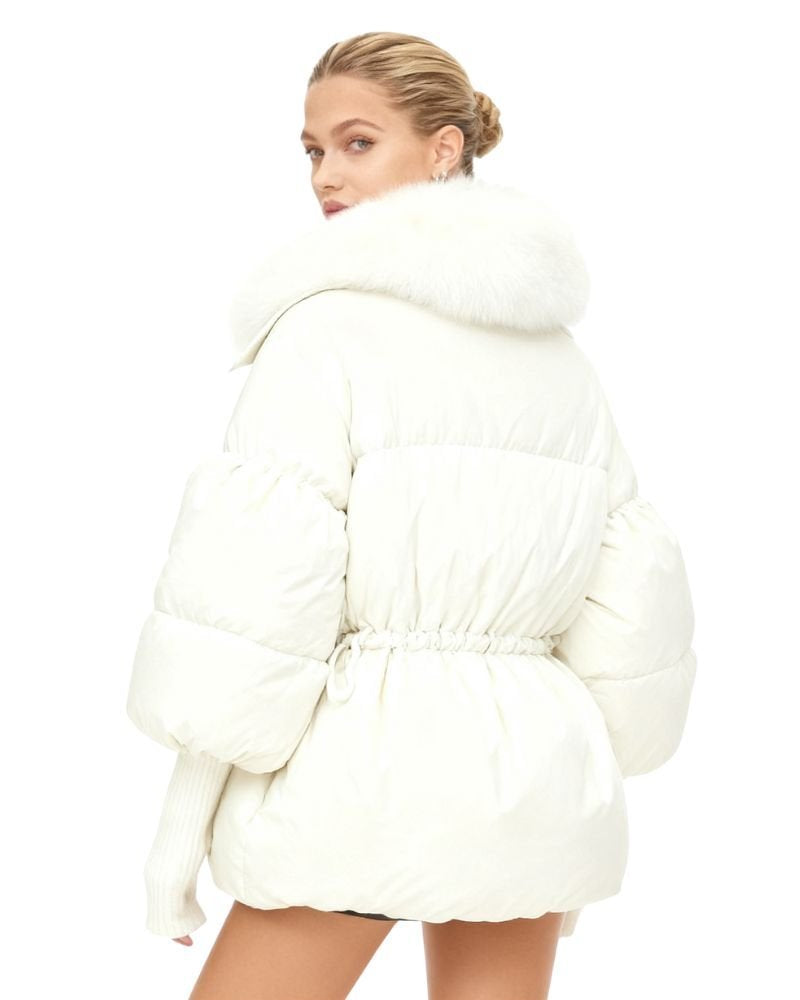 Person wearing a white kouvr puffer coat on a white background