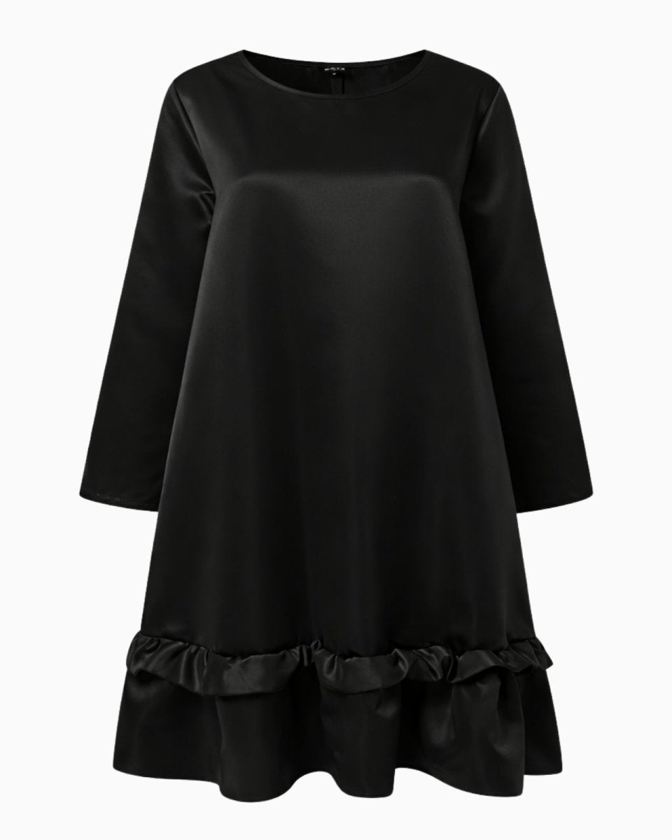 Flatlay of a black long sleeve satin dress with a round neck and ruffle hem detail.