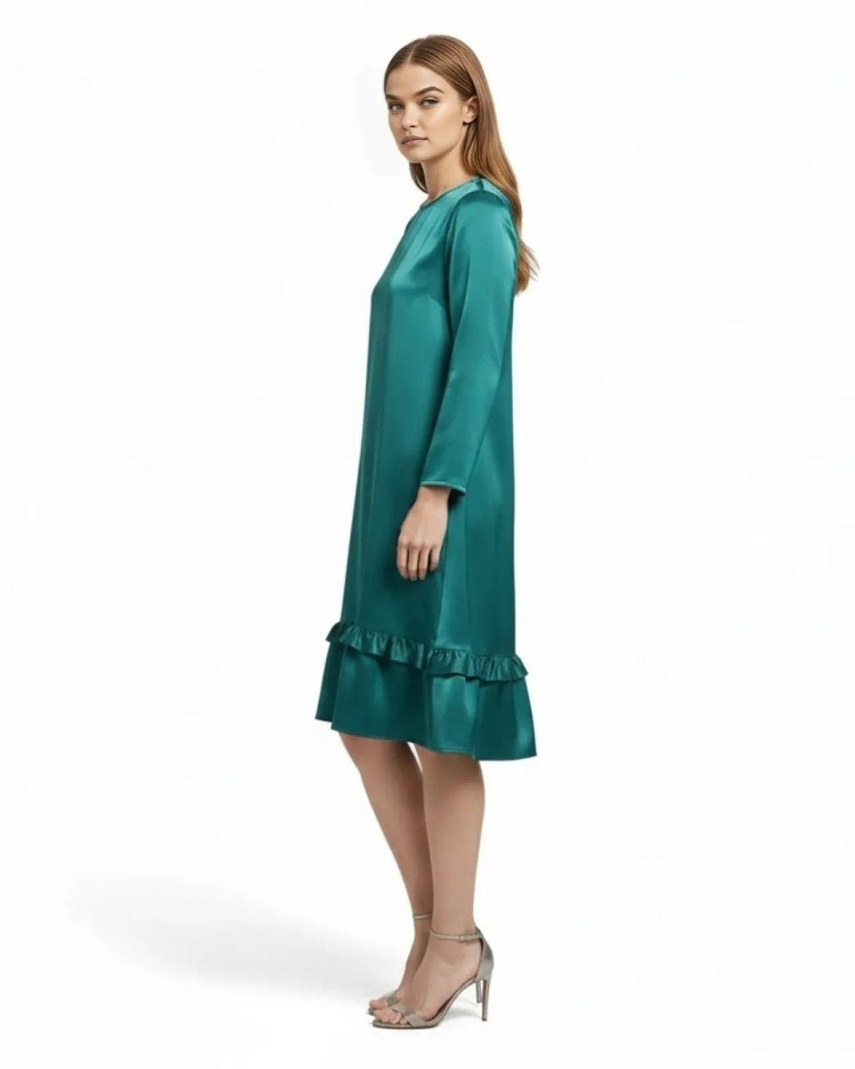 Side profile of a model in the Adalee Teal satin knee-length dress showing its A-line silhouette.