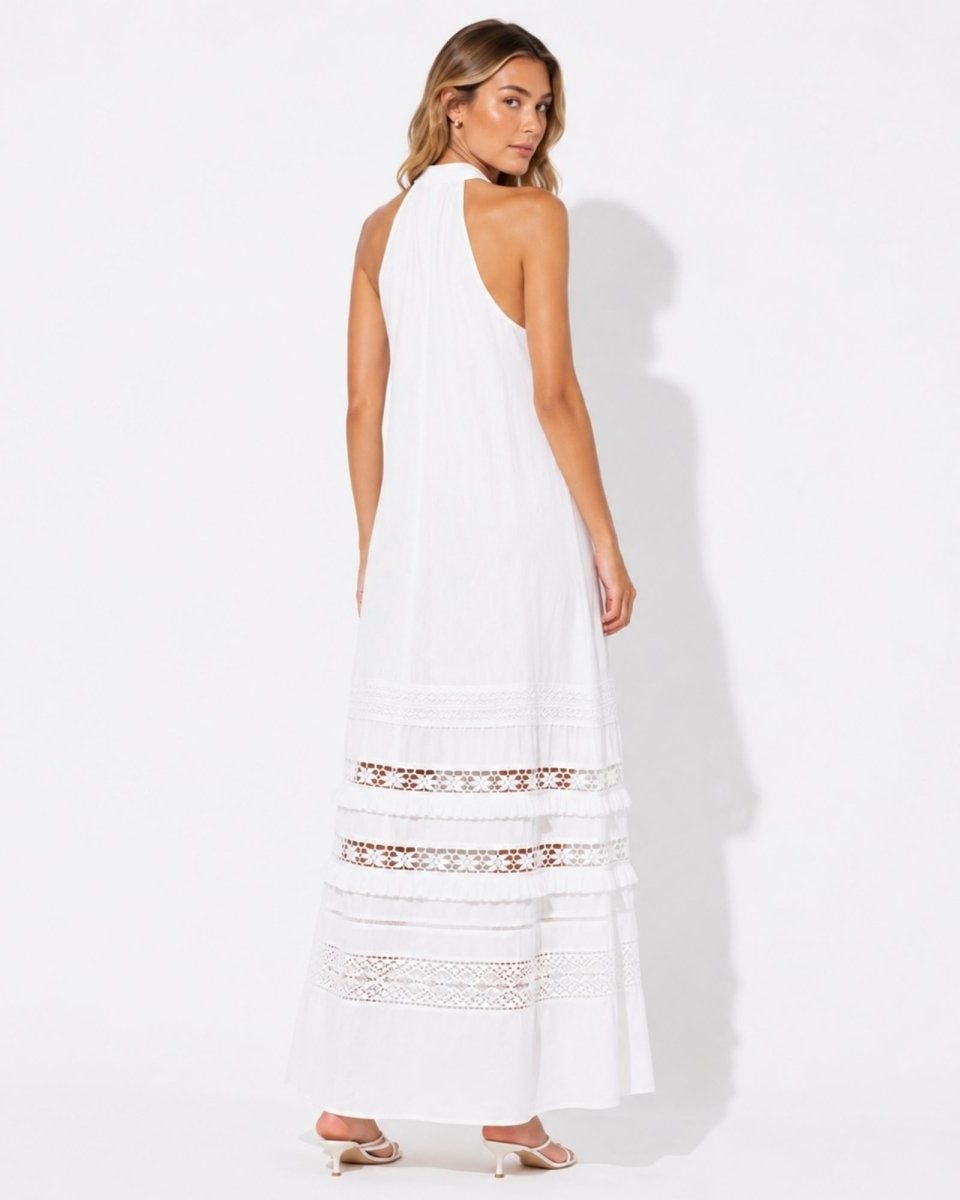 Back view of the boho luxury white halter neck vacation dress highlighting the open shoulder design.