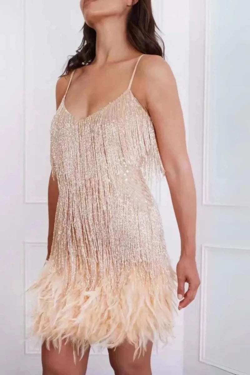 Woman wearing a beige fringe dress against a white background