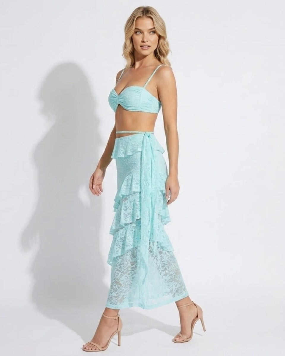 Side profile of elegant light blue lace vacation co-ord featuring a high-waisted draped ruffle skirt and crop top.