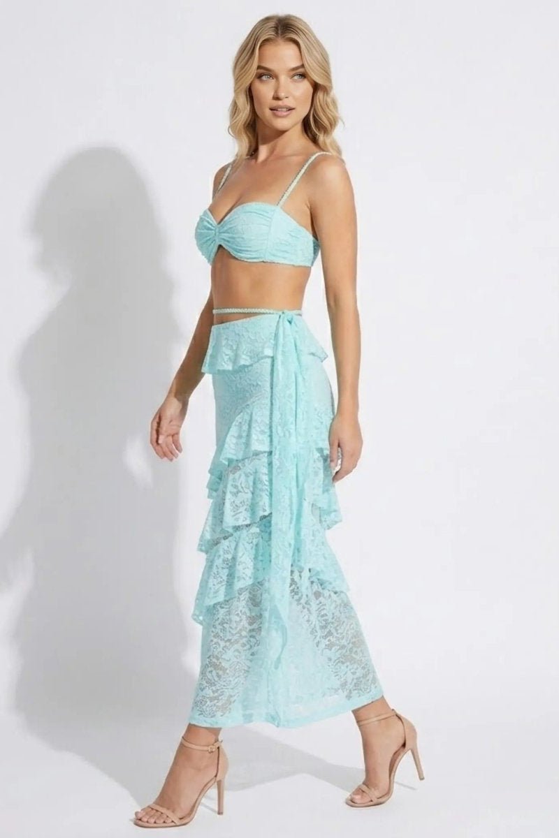 Woman wearing a light blue lace dress on a white background