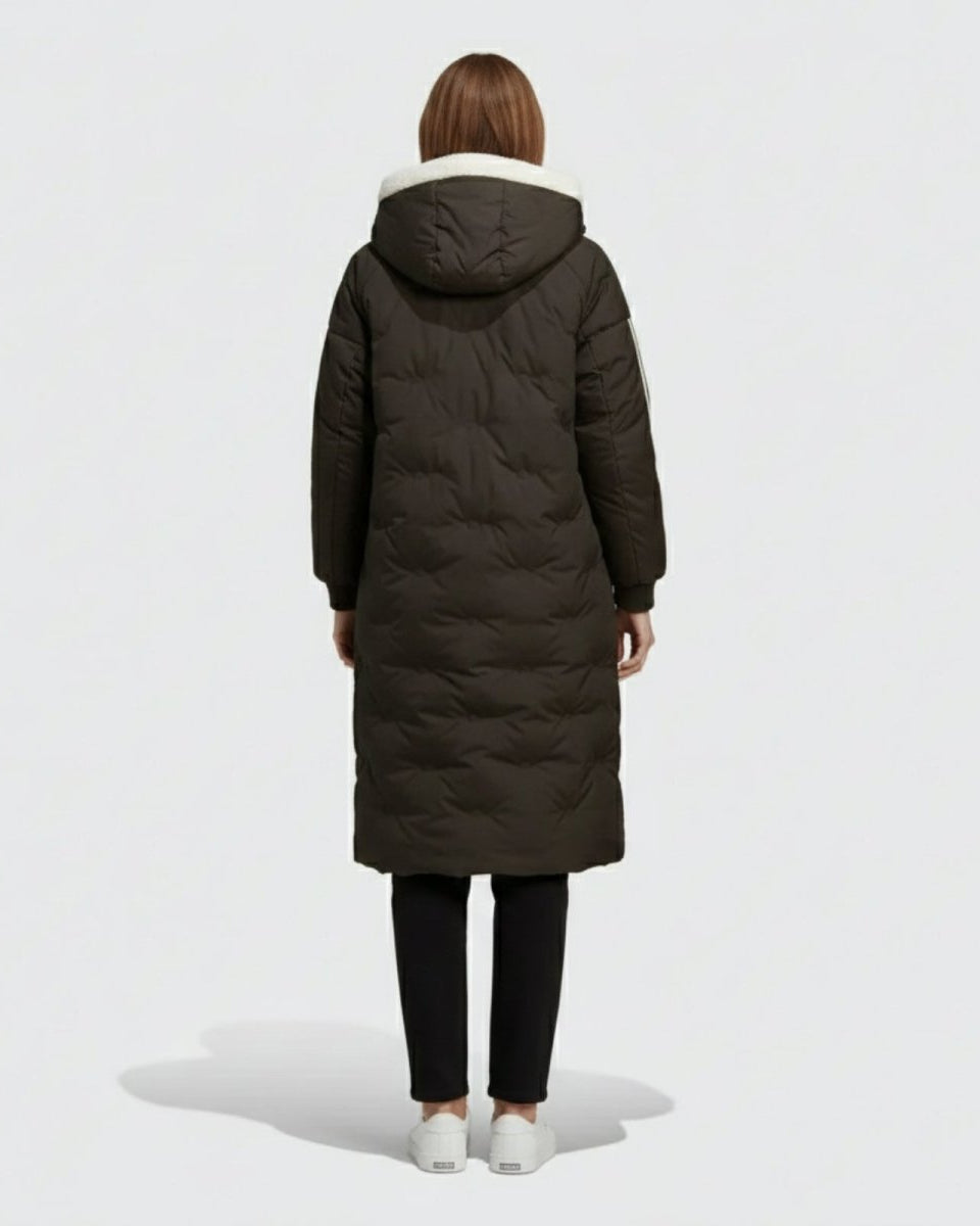 Back view of a model wearing the Arianne hooded down parka, displaying the clean silhouette and quilted pattern of the black coat.