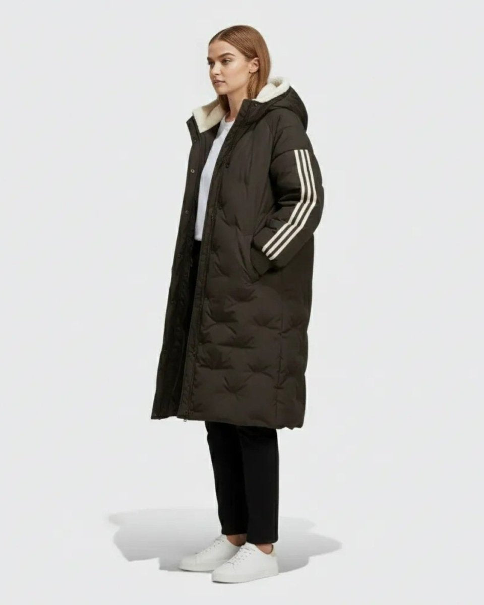 Side view of a model in the Arianne maxi puffer coat in black, showcasing its length and the signature three-stripe detail on the arm.