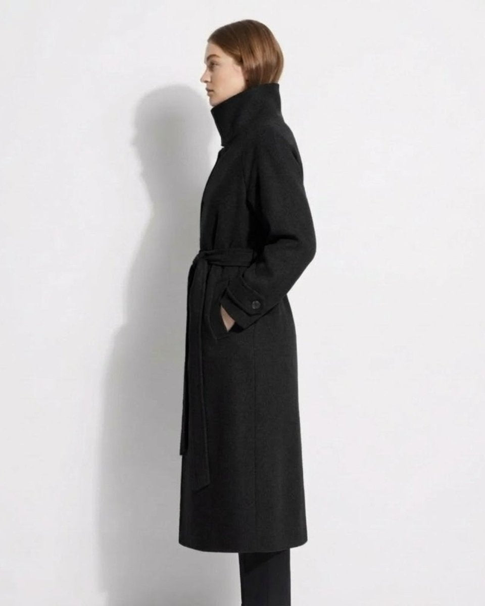 Side profile of the Ashley long black wool wrap coat showing its length and silhouette on a model.