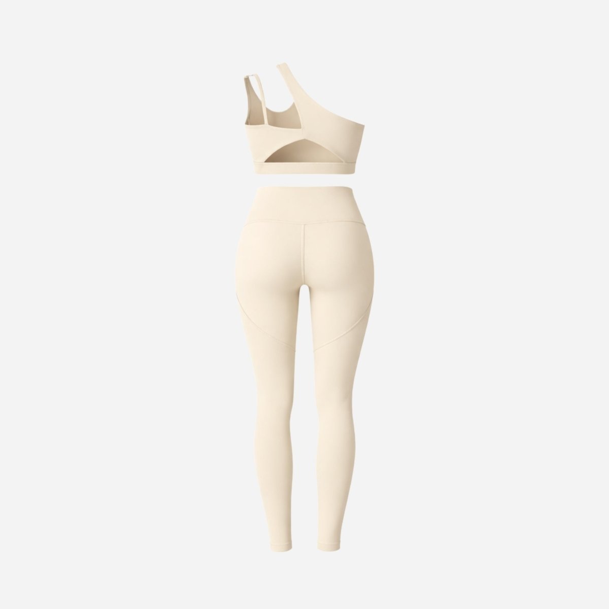 Back view studio flatlay of Kouvr luxury athleisure set showing rear sports bra cutouts and premium legging construction details.