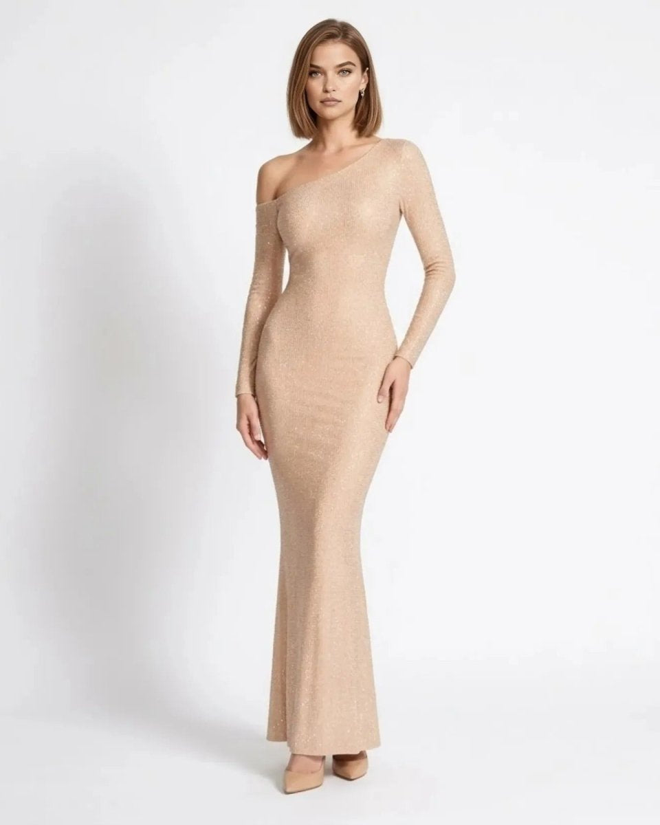 Woman wearing Fenlo asymmetric long sleeve shimmer maxi dress in champagne front view