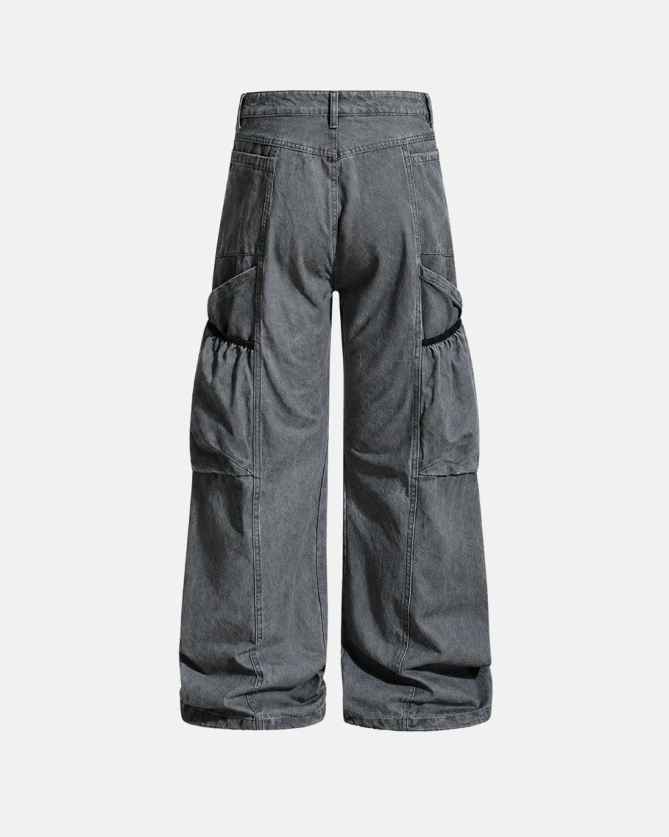 A pair of wide-leg cargo pants in washed dark gray denim, shown from the back against a light gray background.