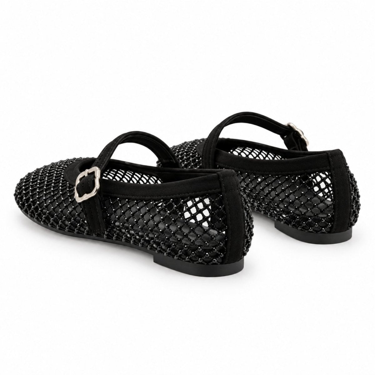 A pair of black open-mesh ballet flats with black straps and silver-tone buckle details, shown on a plain white background.