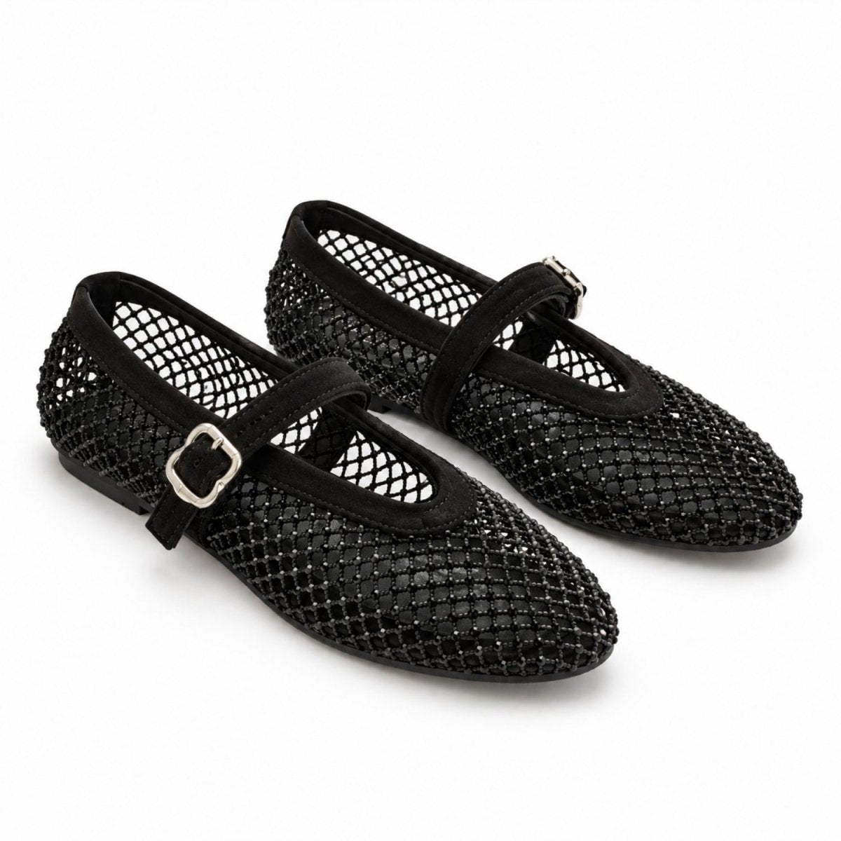 A pair of black open-mesh Mary Jane flats with black straps and silver buckle details, shown on a clean white background.