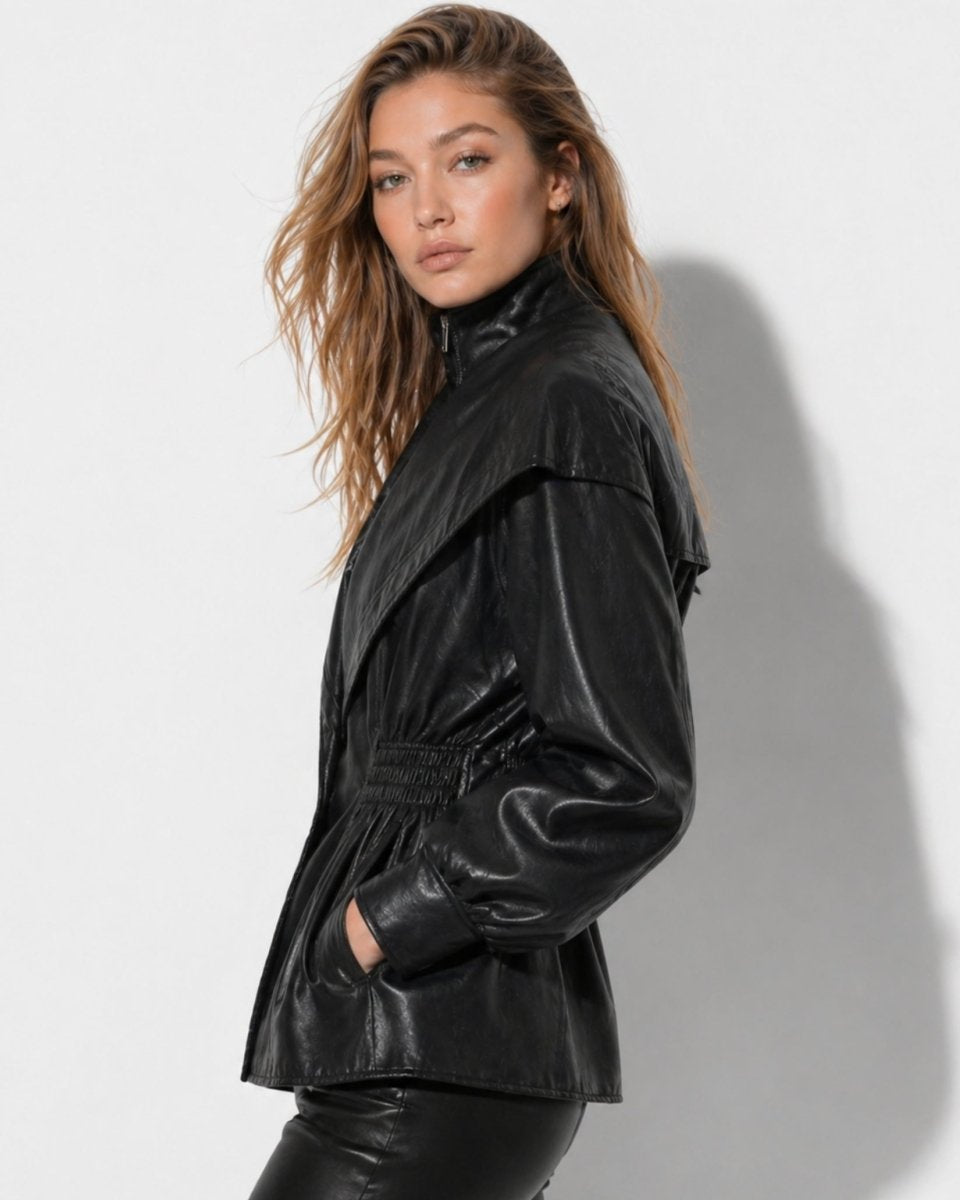 Side profile of woman in black faux leather balloon sleeve jacket with functional pockets