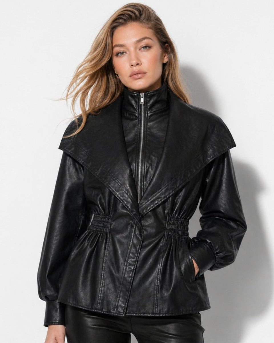 Woman wearing black faux leather peplum jacket with oversized collar and cinched waist facing forward.