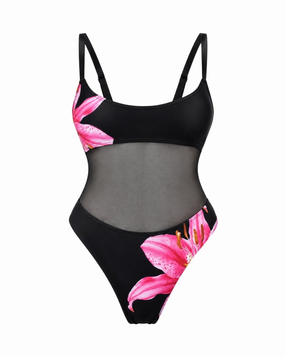 A black one-piece swimsuit with a sheer mesh center panel and vibrant pink lily floral prints on the cups and lower left leg, shown against a plain white background.