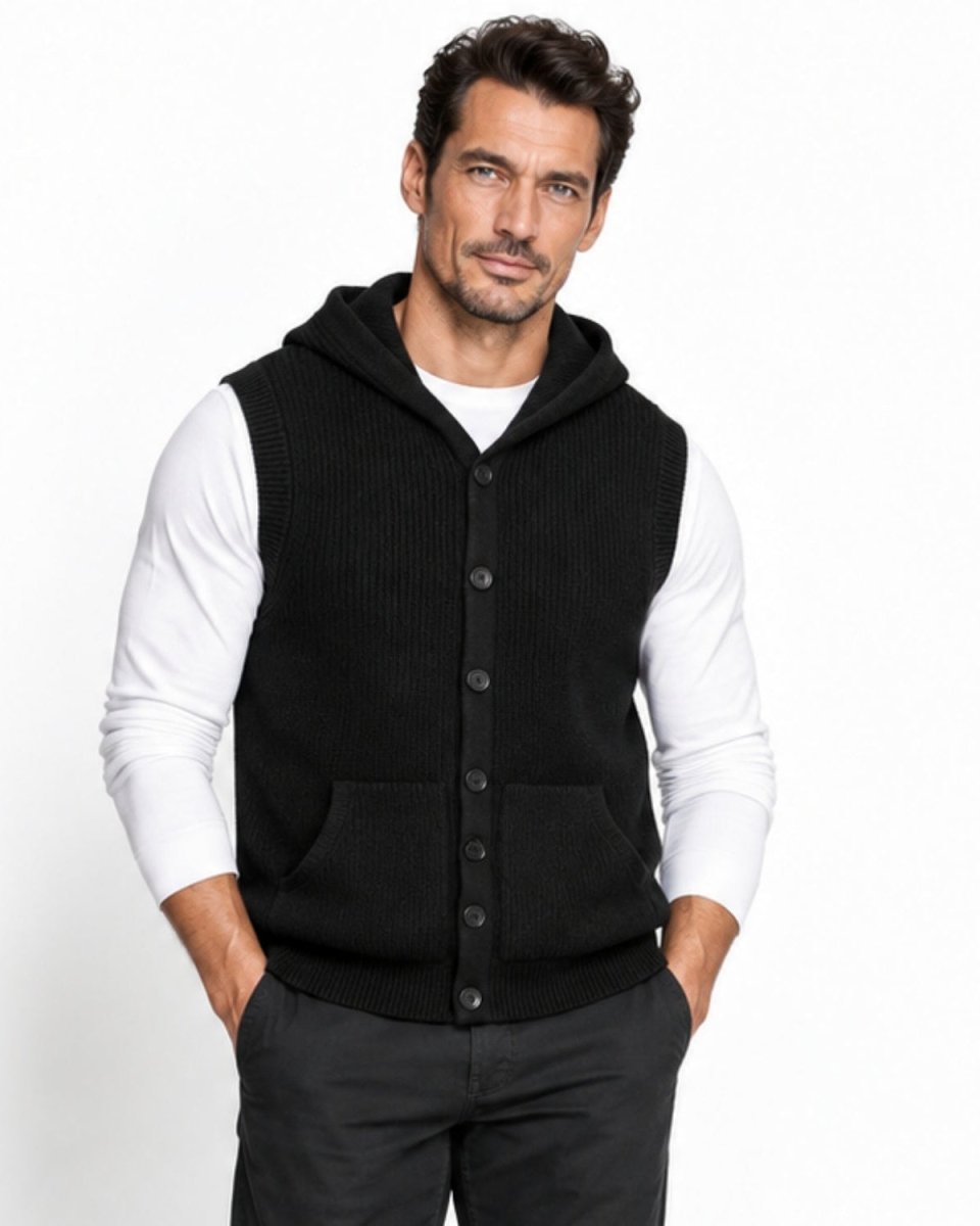 Mature man wearing a black luxury hooded sweater vest with a button down front layered over a white long sleeve shirt