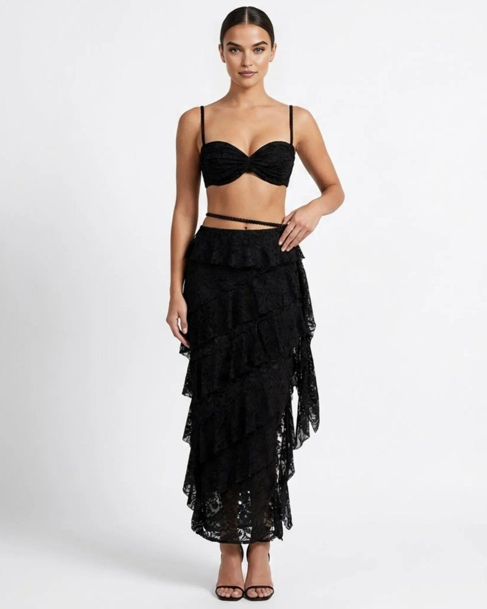 Woman wearing black sheer lace two piece matching set with tiered ruffle maxi skirt and sweetheart bralette front view