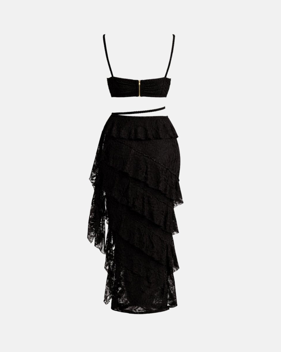 Flat lay back view of black lace matching set highlighting the back zipper closure and asymmetrical skirt hemline