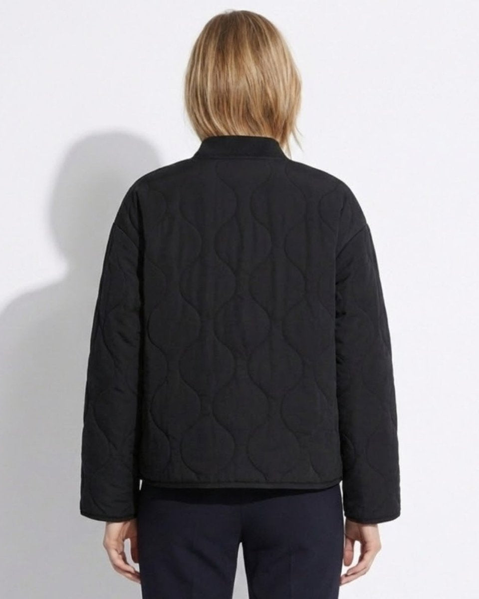 Back view of the women's black onion quilt jacket showing its relaxed silhouette.