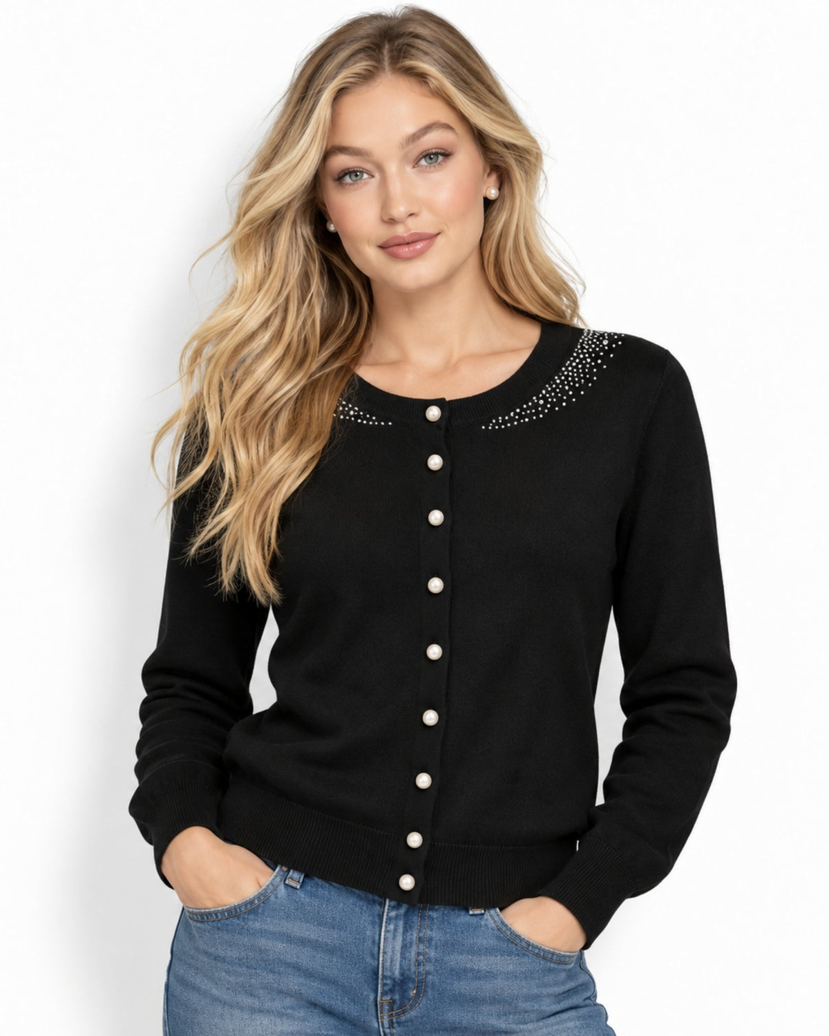 A woman modeling a black long-sleeve cardigan with white buttons and rhinestone embellishments around the neckline, paired with blue jeans against a plain white background.