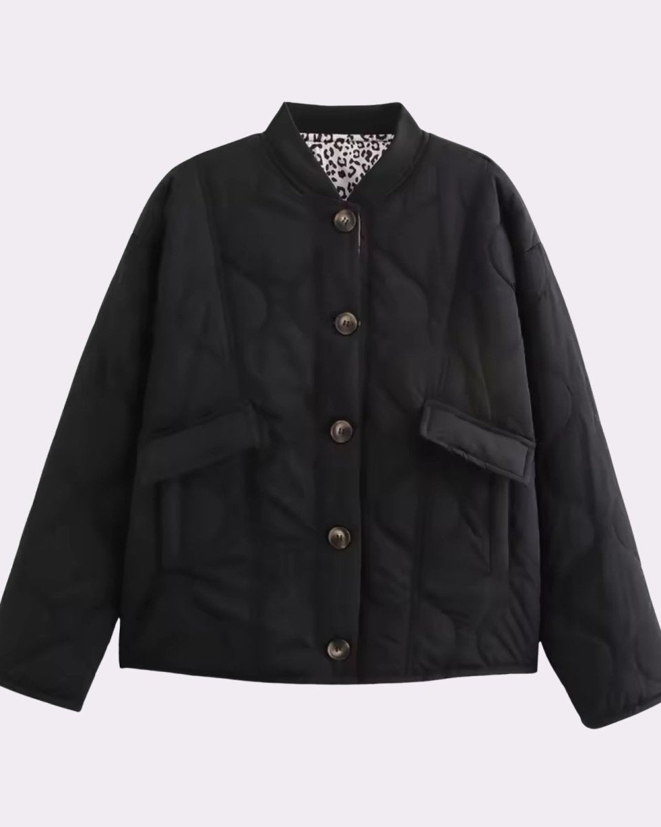 Flat lay of the black quilted jacket, open to show the interior leopard print lining and horn-effect buttons.