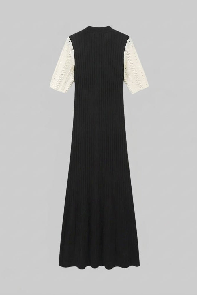 Flat lay back view of the Fenlo Form black ribbed knit maxi dress showing the stretch ribbed fabric texture and contrasting sleeves.