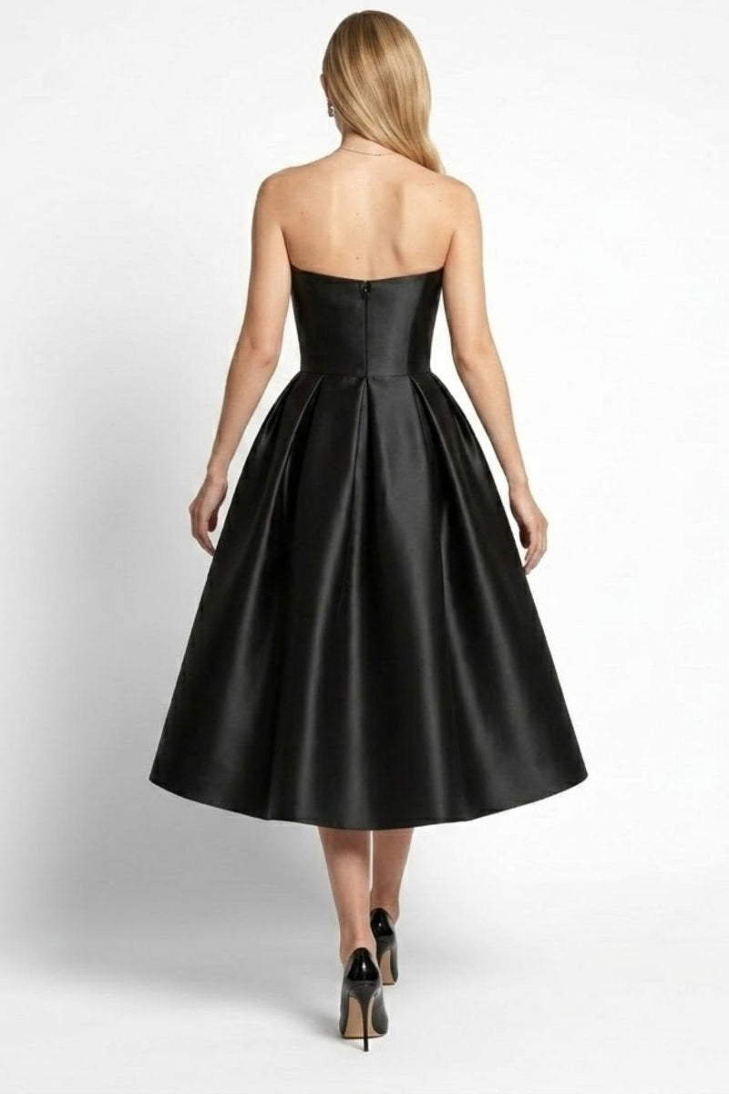 Back view of black satin strapless formal midi dress showing hidden zipper closure and flared skirt by Fenlo Form