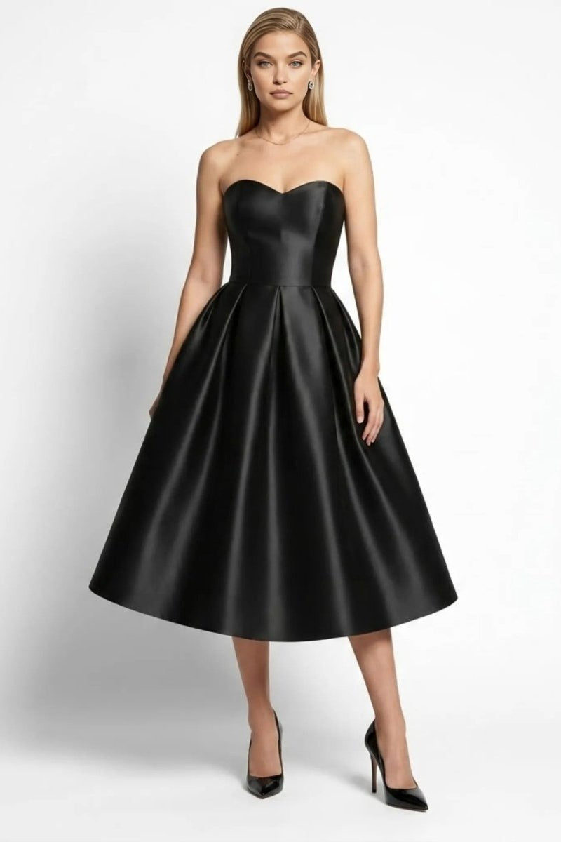 Front view of woman wearing elegant black satin strapless sweetheart neckline midi cocktail dress by Fenlo Form