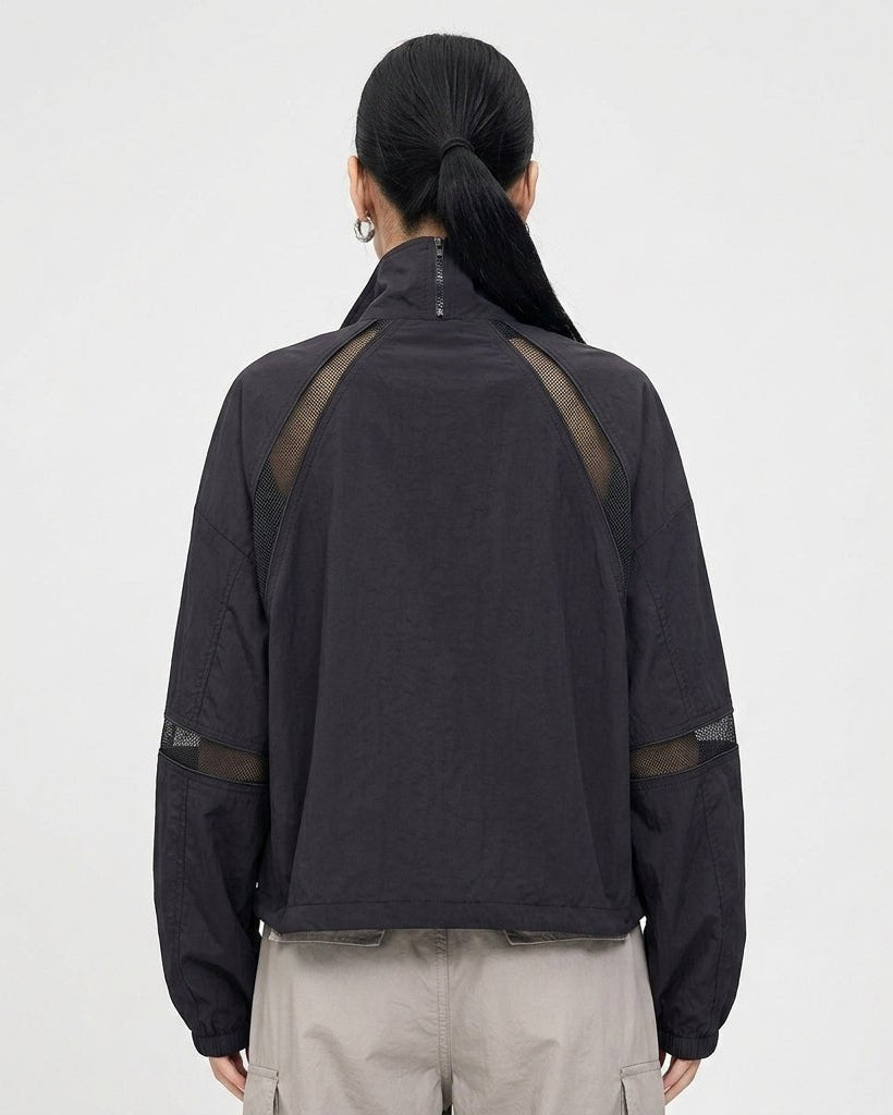 Back view of Kouvr black sporty lightweight jacket showing geometric diagonal mesh shoulder detailing
