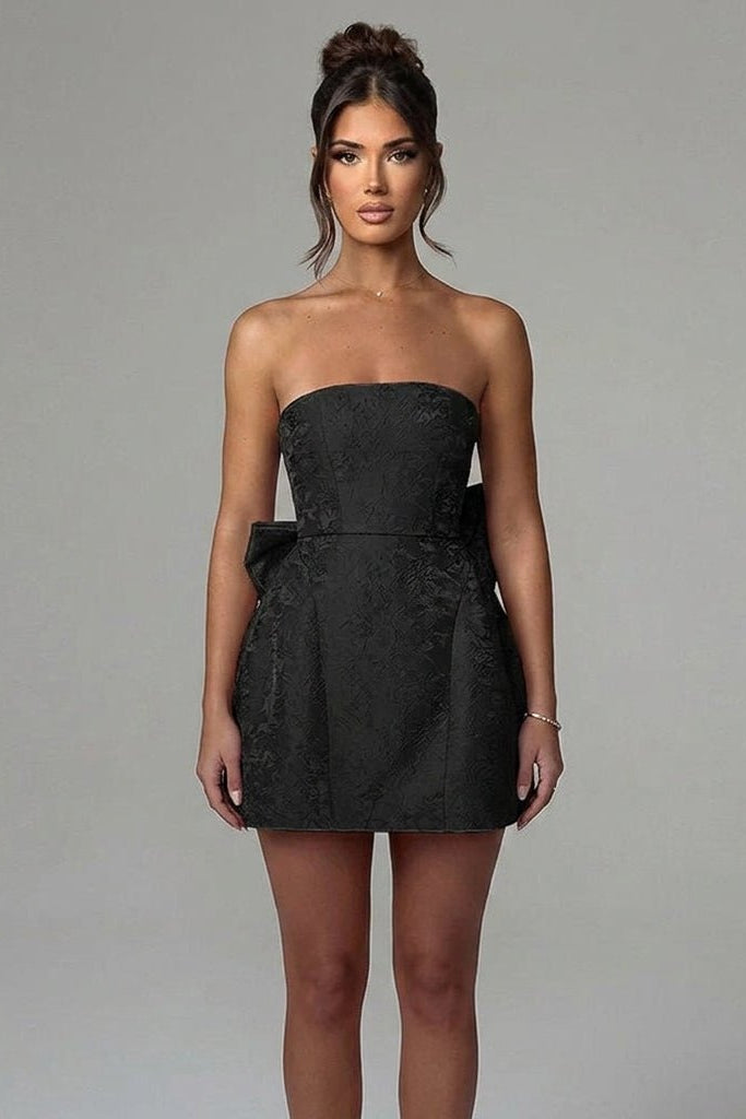 Front view of female model wearing a black strapless structured jacquard mini dress by affordable luxury brand Fenlo Form.