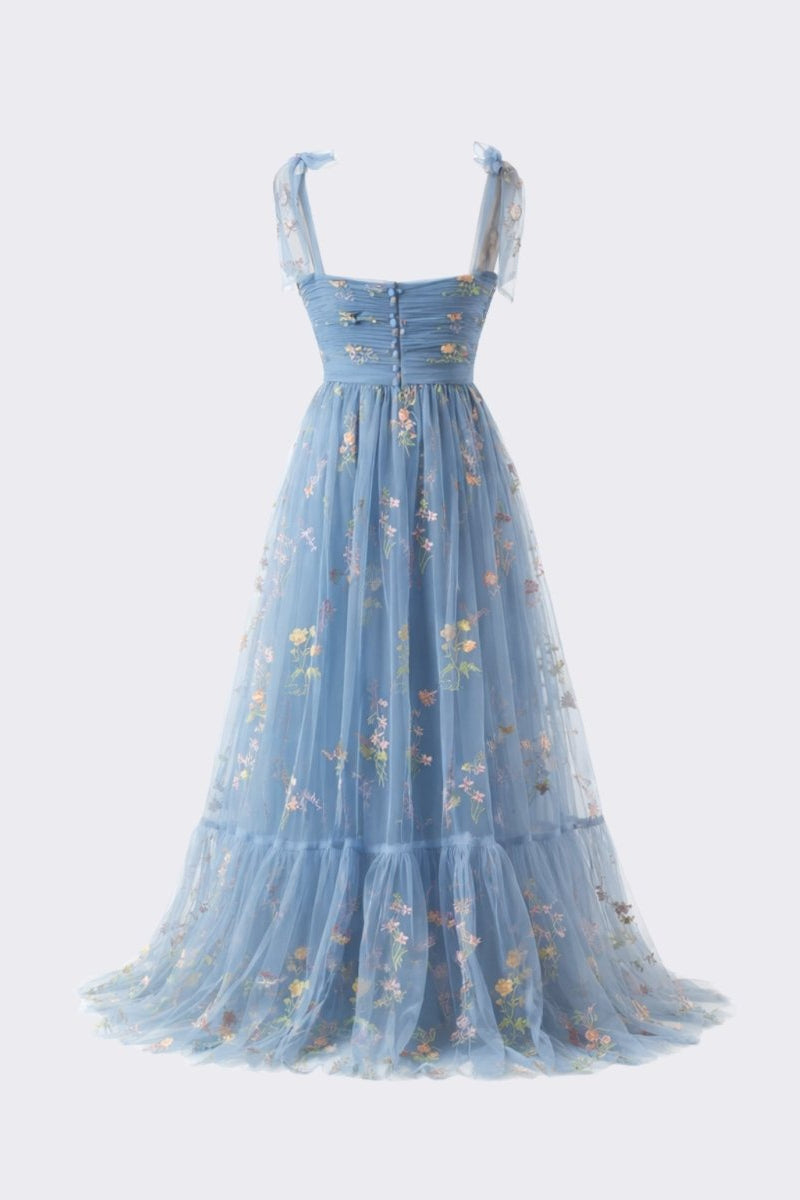 Studio flat lay back view of the Fenlo Form blue floral tulle dress detailing the elegant button back closure and lightweight mesh floral overlay.