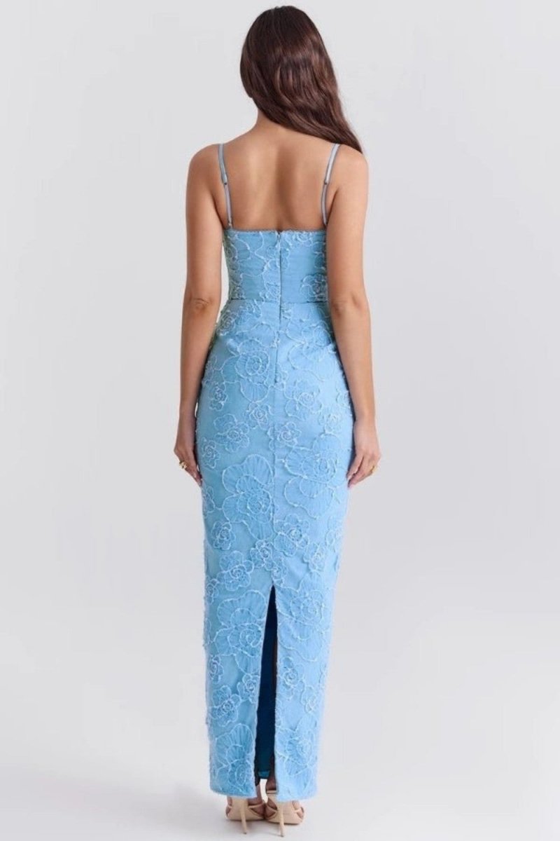 Woman wearing a light blue lace dress with a slit on a white background