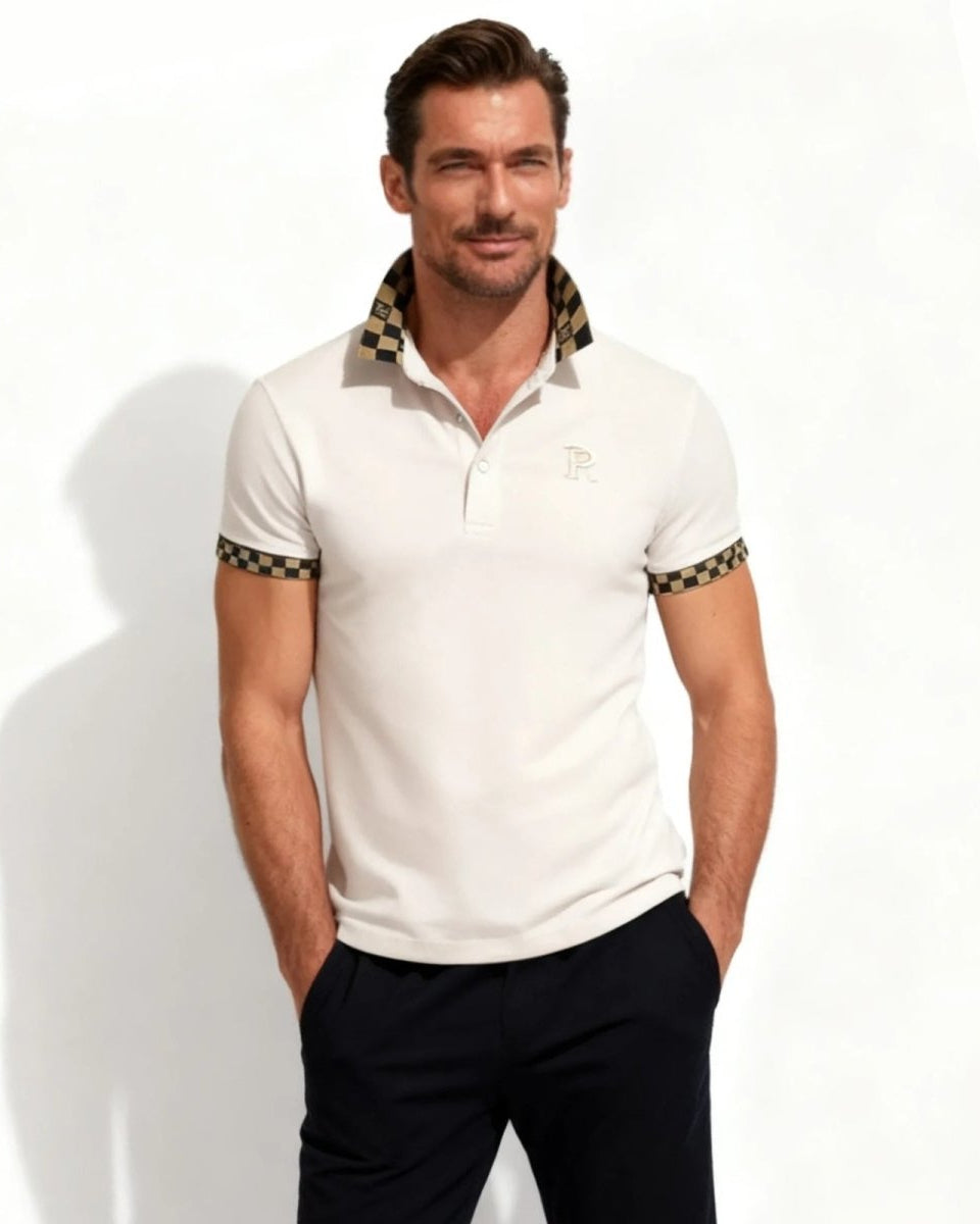Model wearing the men's designer polo shirt in pink with a black and gold checkered contrast collar.