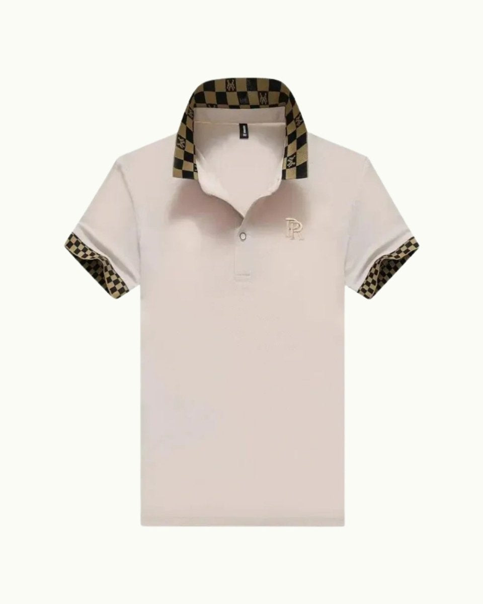 Flatlay product shot of the pink polo shirt with its signature black and gold monogram check collar and embroidered chest logo.