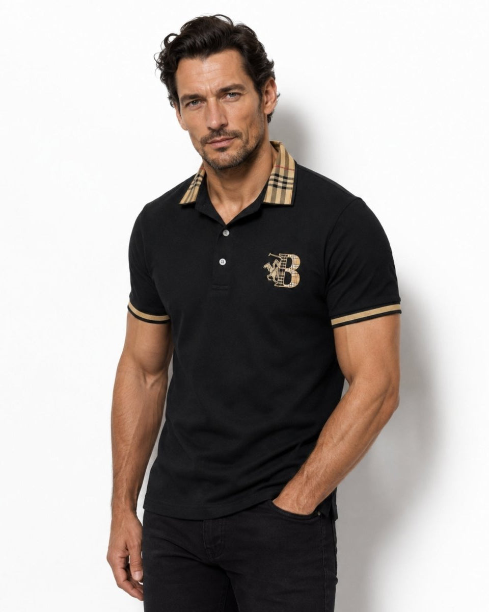 Man wearing a black polo shirt with a logo on a white background
