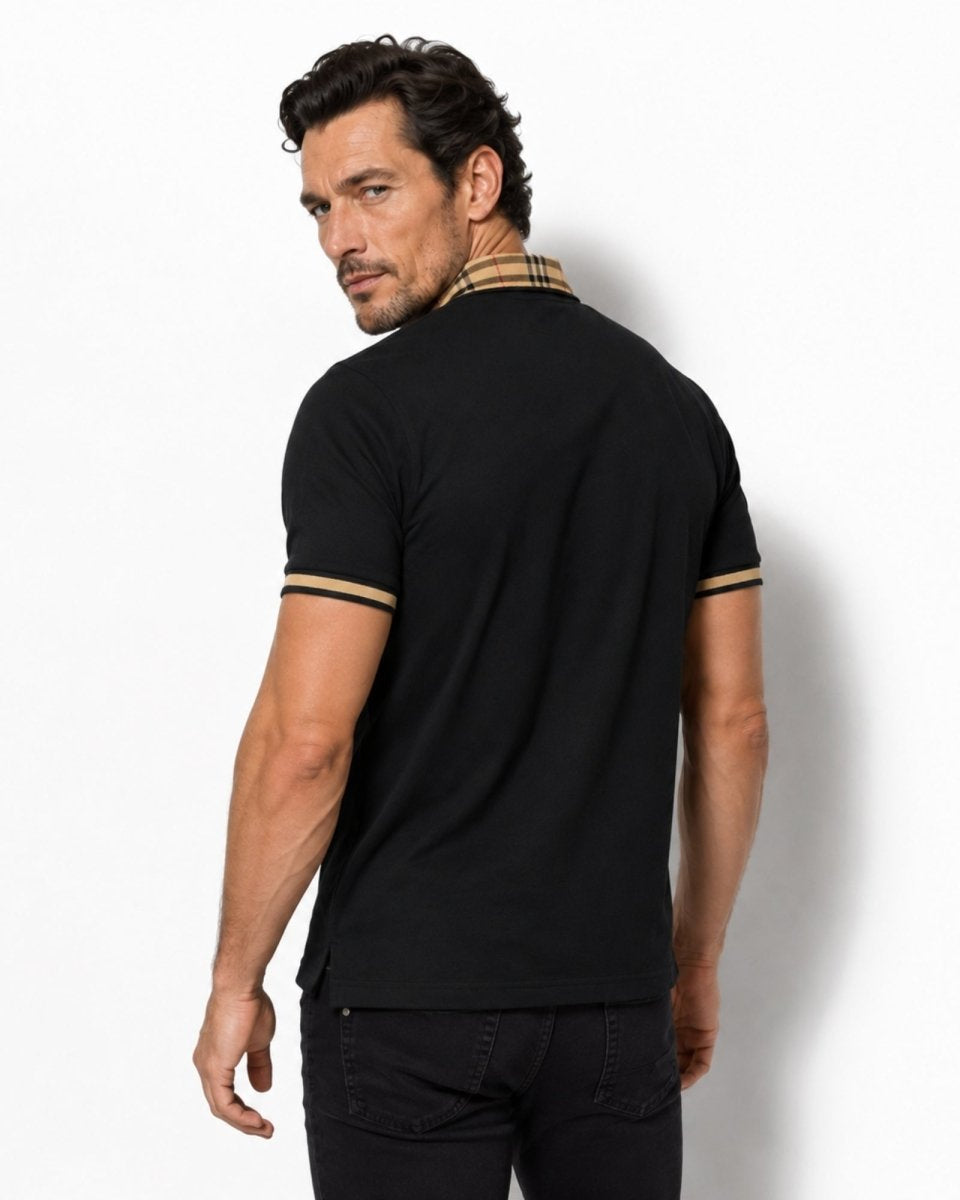 Man wearing a black polo shirt with plaid collar against a white background