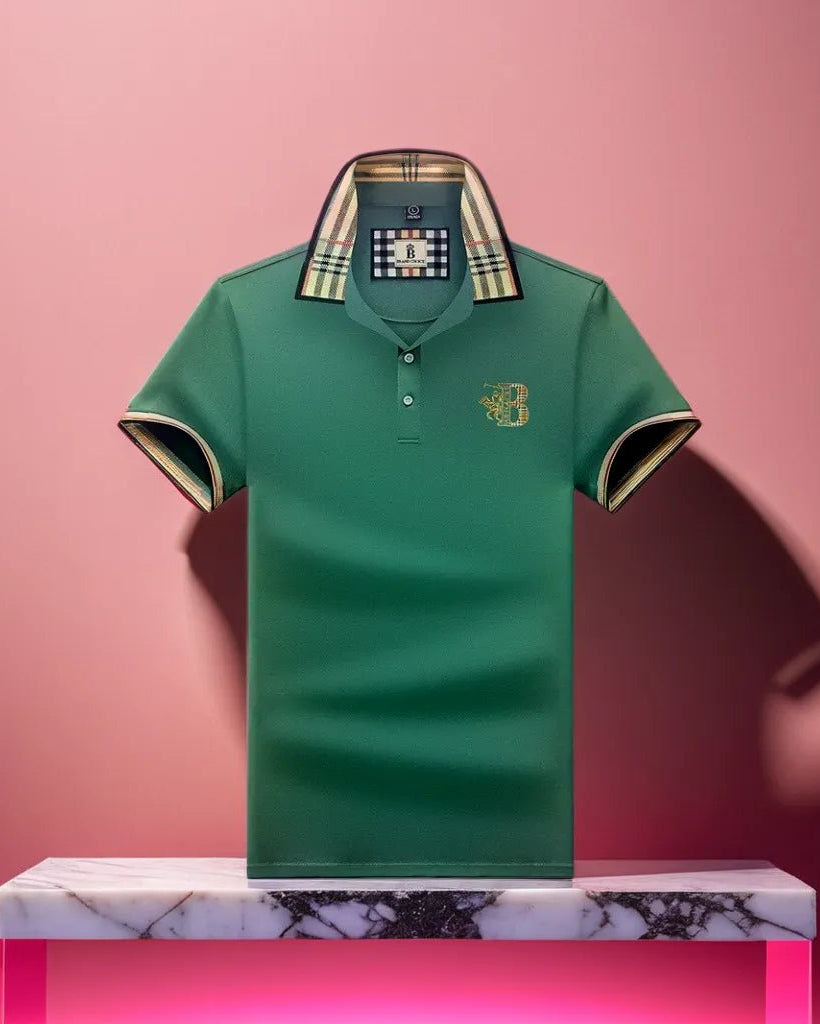 Green polo shirt with plaid collar on a pink background