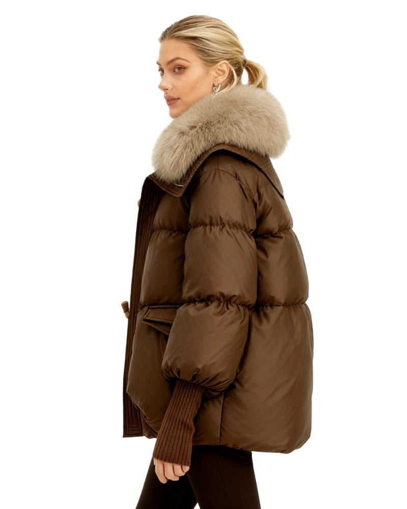 Brown fenlo form puffer jacket with fur hood worn by a model on a white background