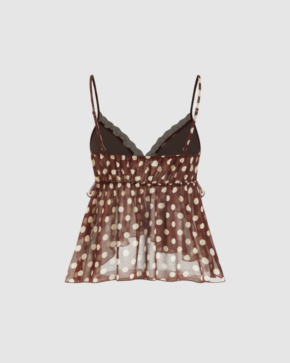 A sheer brown camisole top with white polka dots, featuring a smocked waist and scalloped lace trim along the V-neckline, displayed against a solid light gray background.