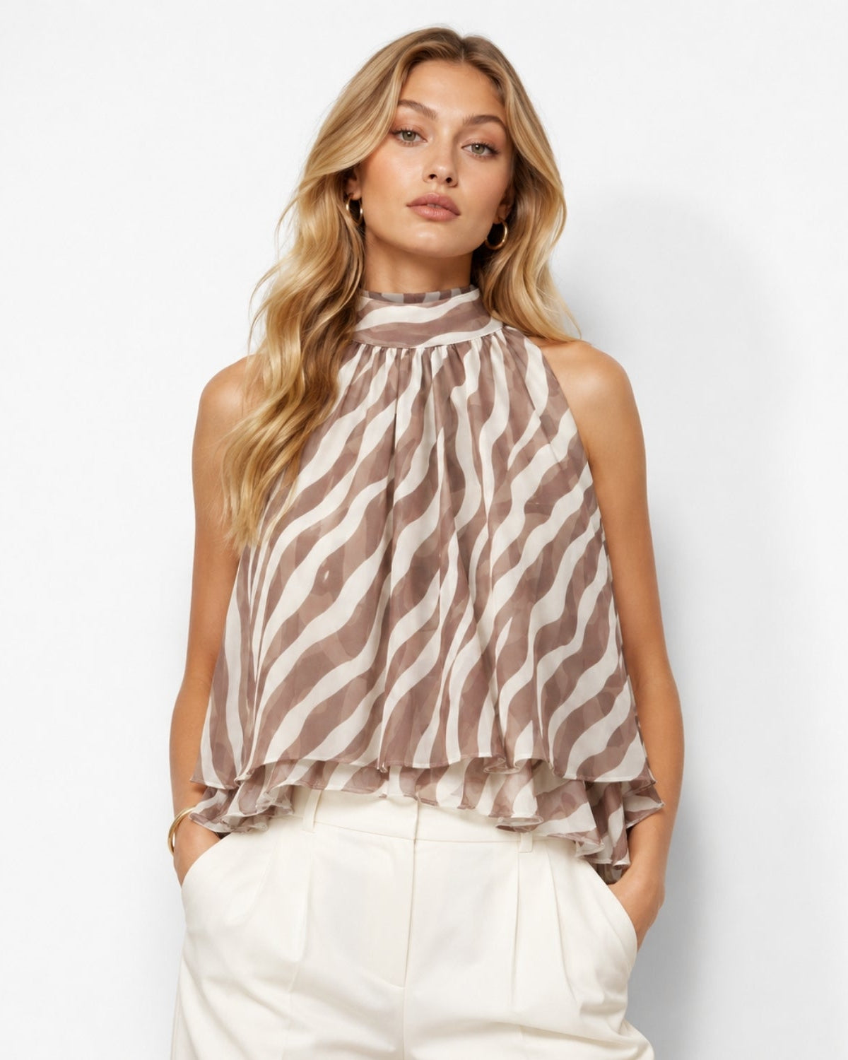 Sophisticated women's trapeze style halter top featuring a brown and white zebra animal print on lightweight chiffon material.